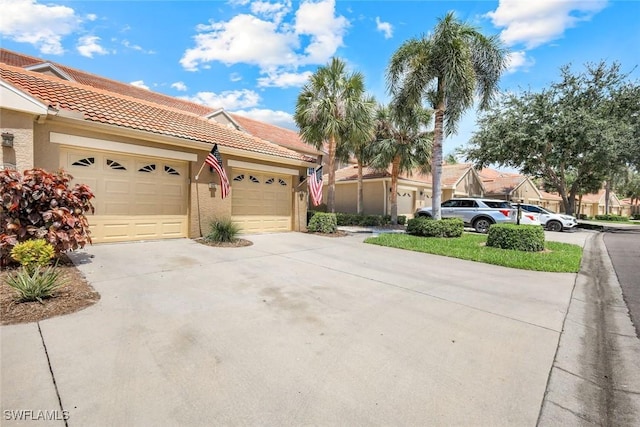 20101 Seagrove St Unit 702, Estero, FL 33928 - view of front of home featuring driveway, stucco siding, an attached garage, and a tiled roof