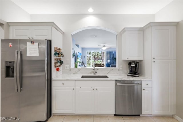 20101 Seagrove St Unit 702, Estero, FL 33928 - kitchen with appliances with stainless steel finishes, a sink, light stone countertops, ceiling fan, and white cabinets