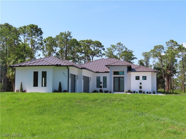 3813 16th Ave NE, Naples, FL 34120 - view of front of home featuring a standing seam roof, metal roof, stucco siding, and a front yard