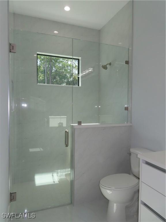 3813 16th Ave NE, Naples, FL 34120 - full bath featuring a shower stall, toilet, vanity, and recessed lighting