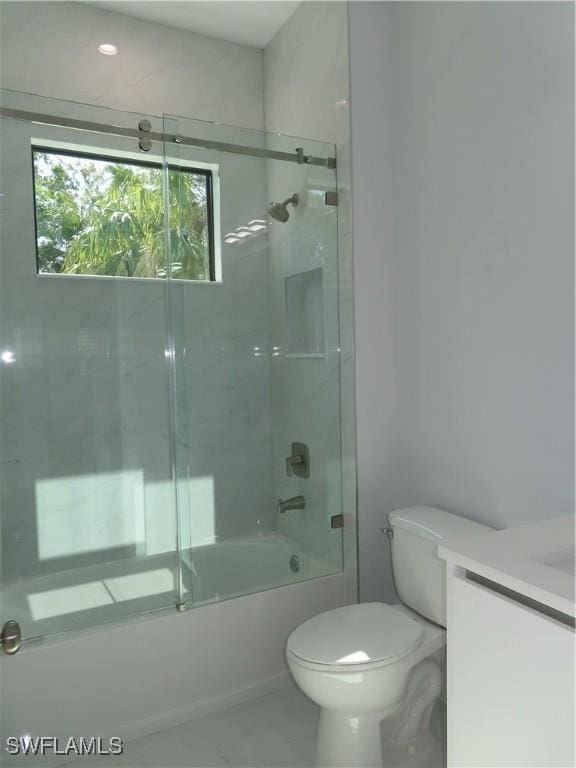 3813 16th Ave NE, Naples, FL 34120 - bathroom featuring toilet, enclosed tub / shower combo, and vanity