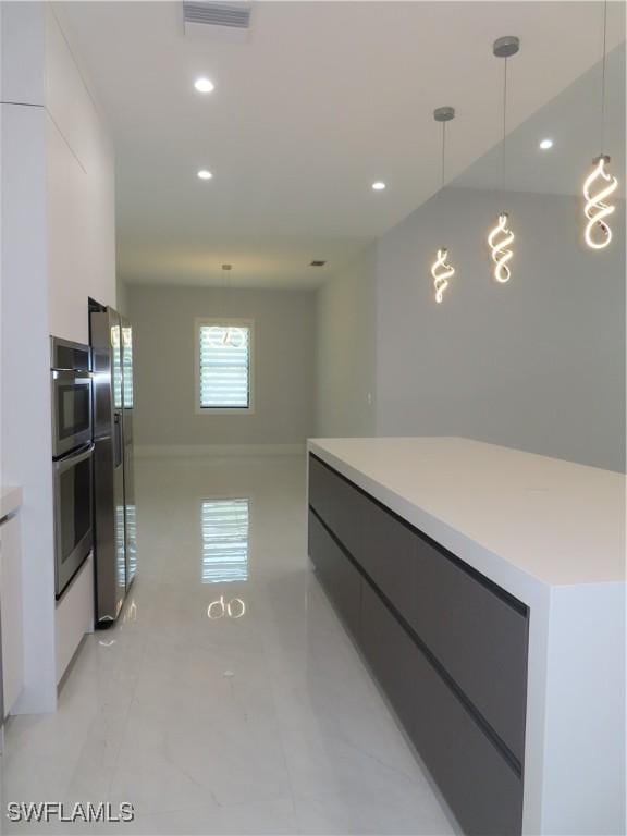 3813 16th Ave NE, Naples, FL 34120 - kitchen with modern cabinets, stainless steel fridge, a center island, white cabinets, and recessed lighting