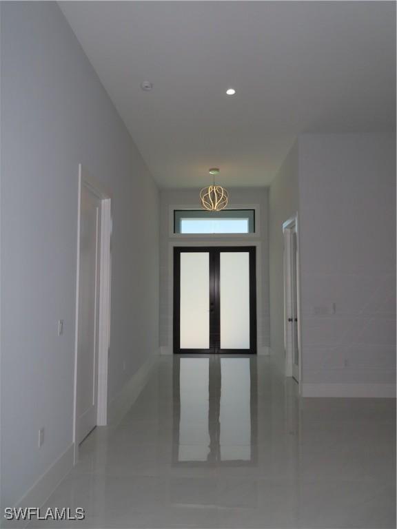 3813 16th Ave NE, Naples, FL 34120 - corridor with baseboards, light tile patterned floors, and recessed lighting