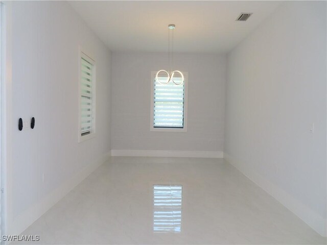 3813 16th Ave NE, Naples, FL 34120 - empty room with a chandelier and baseboards