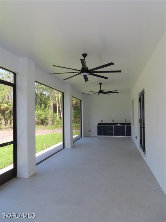 3813 16th Ave NE, Naples, FL 34120 - unfurnished sunroom featuring plenty of natural light