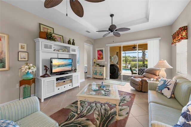 10450 Materita Dr, Fort Myers, FL 33913 - living room with ceiling fan, light tile patterned flooring, a tray ceiling, and baseboards