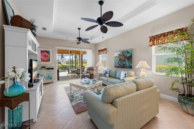 10450 Materita Dr, Fort Myers, FL 33913 - living area featuring a raised ceiling, light tile patterned floors, a ceiling fan, and baseboards