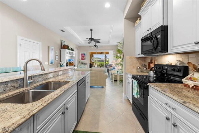 10450 Materita Dr, Fort Myers, FL 33913 - kitchen featuring black appliances, a sink, a raised ceiling, a ceiling fan, and light tile patterned floors