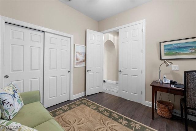 10450 Materita Dr, Fort Myers, FL 33913 - office area featuring dark wood-style floors, baseboards, and arched walkways