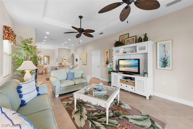 10450 Materita Dr, Fort Myers, FL 33913 - living room featuring a ceiling fan, light tile patterned flooring, a tray ceiling, baseboards, and recessed lighting