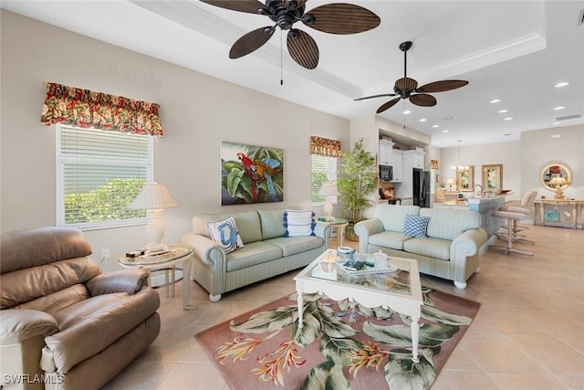 10450 Materita Dr, Fort Myers, FL 33913 - living room featuring a ceiling fan, light tile patterned floors, a raised ceiling, healthy amount of natural light, and recessed lighting