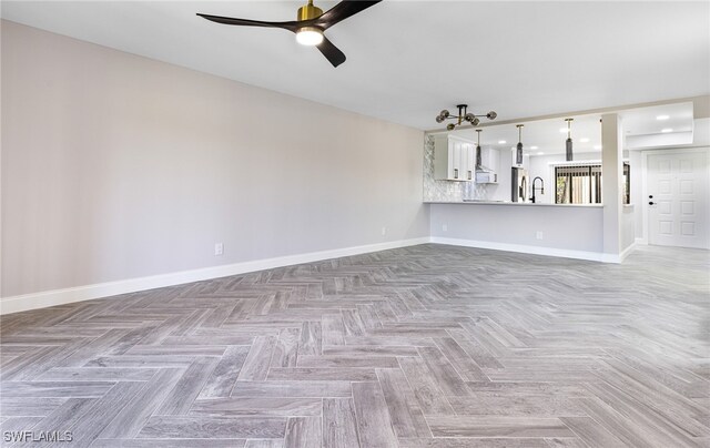 16320 Kelly Cove Dr Unit 267, Fort Myers, FL 33908 - unfurnished living room featuring a ceiling fan and baseboards