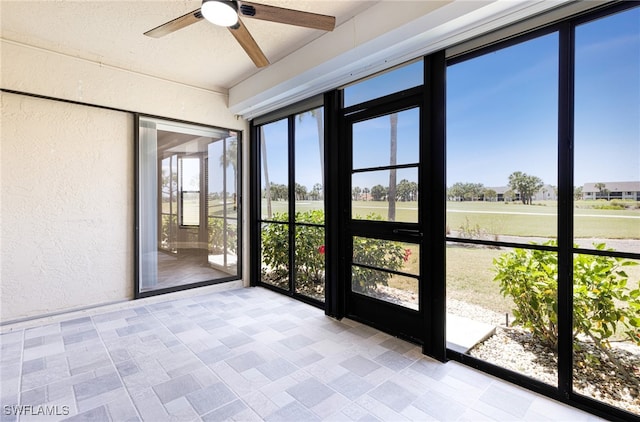 16320 Kelly Cove Dr Unit 267, Fort Myers, FL 33908 - unfurnished sunroom with a textured wall, ceiling fan, and plenty of natural light
