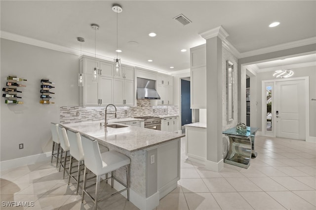 4172 Crescent Ct, Naples, FL 34119 - kitchen featuring a sink, wall chimney range hood, crown molding, high end stainless steel range, and decorative backsplash