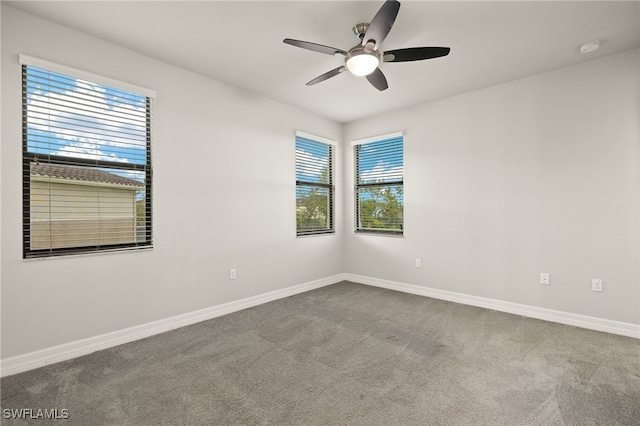4172 Crescent Ct, Naples, FL 34119 - spare room featuring dark colored carpet, a ceiling fan, and baseboards