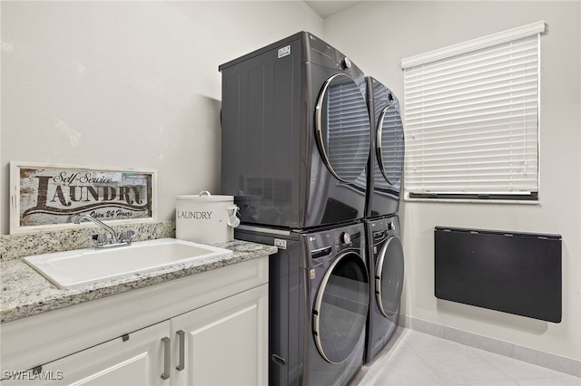 4172 Crescent Ct, Naples, FL 34119 - washroom featuring stacked washer and clothes dryer, light tile patterned floors, and cabinet space