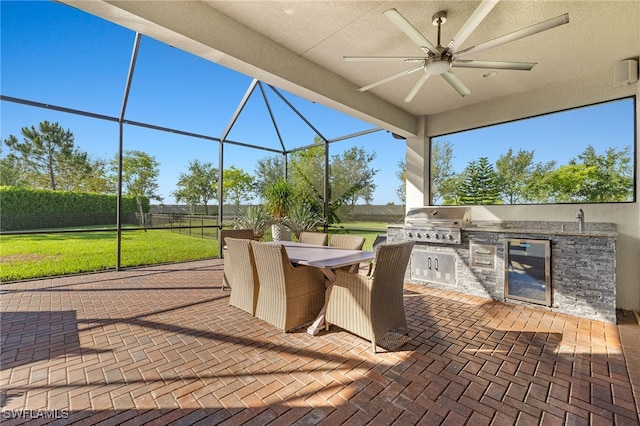 4172 Crescent Ct, Naples, FL 34119 - view of patio / terrace featuring beverage cooler, ceiling fan, outdoor dining space, glass enclosure, and a sink