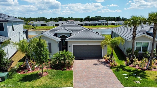 3663 Wild Sage Way, Alva, FL 33920 - ranch-style home with a garage, decorative driveway, a residential view, and stucco siding