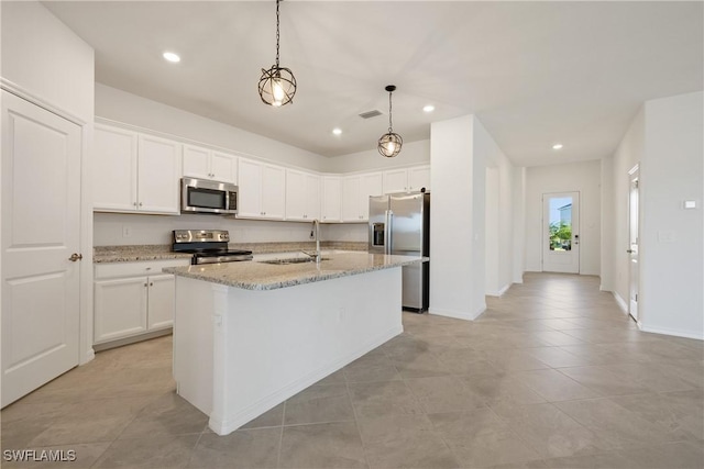 3663 Wild Sage Way, Alva, FL 33920 - kitchen featuring stainless steel appliances, a sink, white cabinets, light stone countertops, and recessed lighting