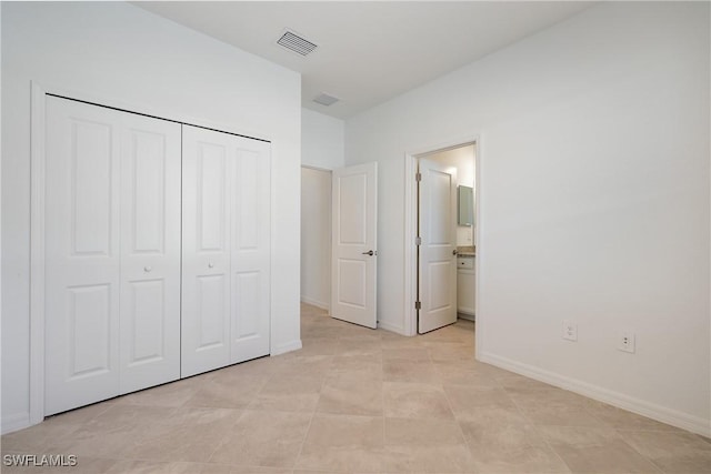 3663 Wild Sage Way, Alva, FL 33920 - unfurnished bedroom with a closet, baseboards, and ensuite bath