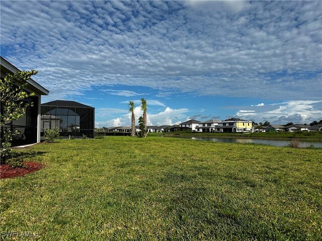 3663 Wild Sage Way, Alva, FL 33920 - view of green lawn featuring a water view, a residential view, and a lanai