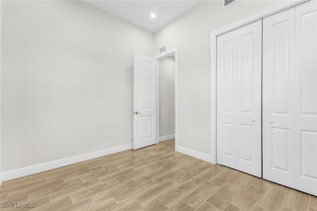 4019 4th St SW, Lehigh Acres, FL 33976 - unfurnished bedroom featuring a closet, light wood-style flooring, and recessed lighting