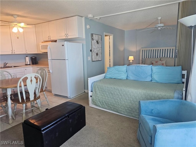 7330 Estero Blvd Unit 601, Fort Myers Beach, FL 33931 - living room featuring a ceiling fan, a textured ceiling, and light carpet