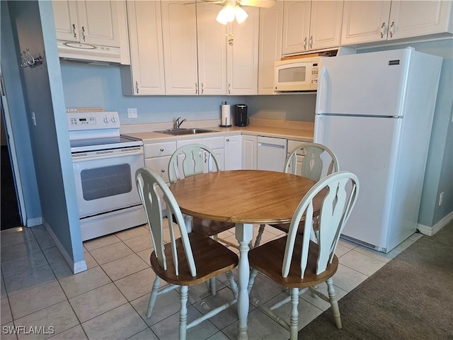 7330 Estero Blvd Unit 601, Fort Myers Beach, FL 33931 - kitchen featuring white appliances, under cabinet range hood, light tile patterned flooring, white cabinetry, and light countertops