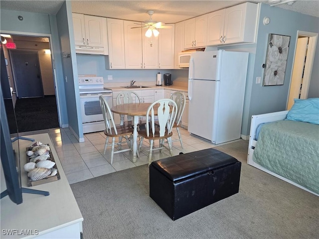7330 Estero Blvd Unit 601, Fort Myers Beach, FL 33931 - kitchen with white appliances, a sink, under cabinet range hood, ceiling fan, and white cabinetry