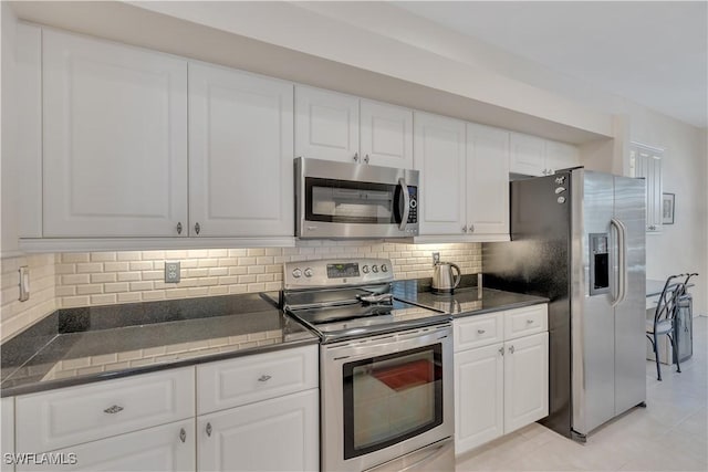 8032 Kilkenny Way Unit G33, Naples, FL 34112 - kitchen with appliances with stainless steel finishes, dark countertops, decorative backsplash, and white cabinets