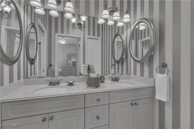 8032 Kilkenny Way Unit G33, Naples, FL 34112 - bathroom featuring wallpapered walls and double vanity