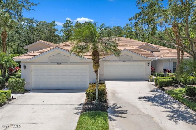 8032 Kilkenny Way Unit G33, Naples, FL 34112 - ranch-style house with driveway, a tile roof, a garage, and stucco siding