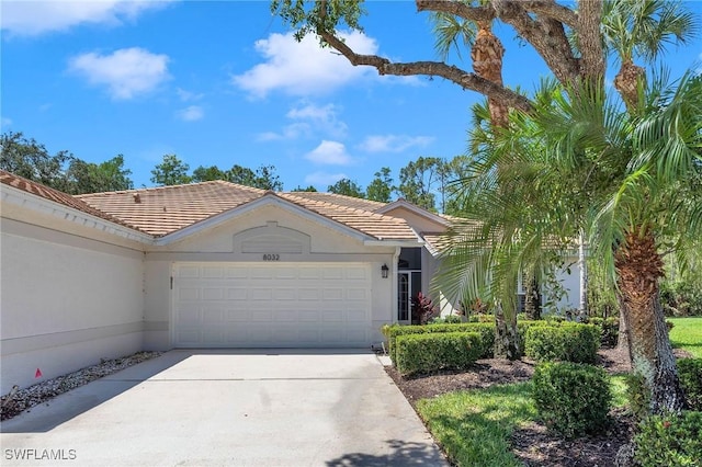 8032 Kilkenny Way Unit G33, Naples, FL 34112 - ranch-style house with an attached garage, concrete driveway, a tiled roof, and stucco siding