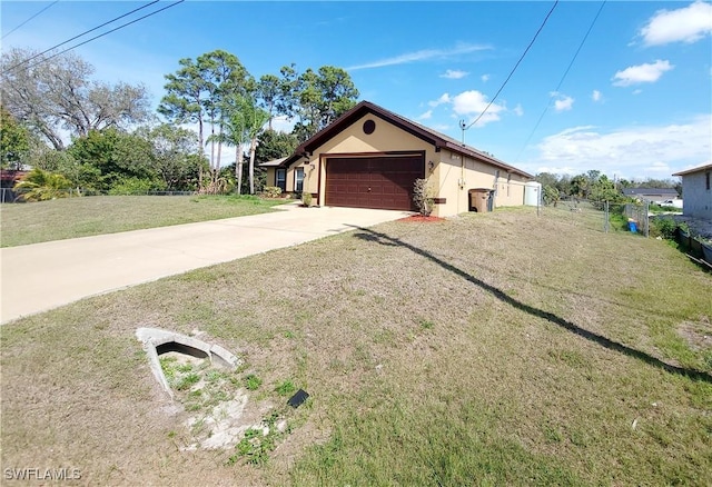506 Desoto Ave, Lehigh Acres, FL 33972 - view of property exterior featuring stucco siding, concrete driveway, and a garage