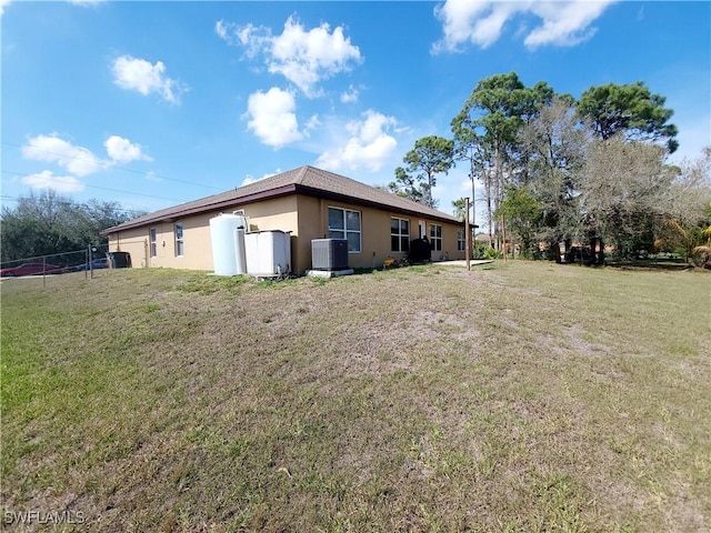 506 Desoto Ave, Lehigh Acres, FL 33972 - view of yard featuring central air condition unit