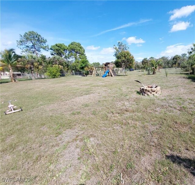 506 Desoto Ave, Lehigh Acres, FL 33972 - view of green lawn with a playground