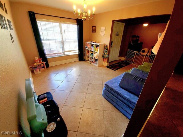 506 Desoto Ave, Lehigh Acres, FL 33972 - tiled living area with a chandelier and baseboards