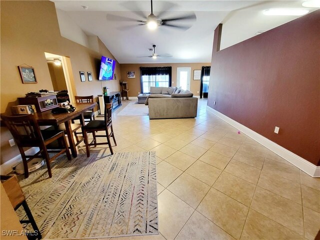 506 Desoto Ave, Lehigh Acres, FL 33972 - living room with vaulted ceiling, a ceiling fan, light tile patterned floors, and baseboards