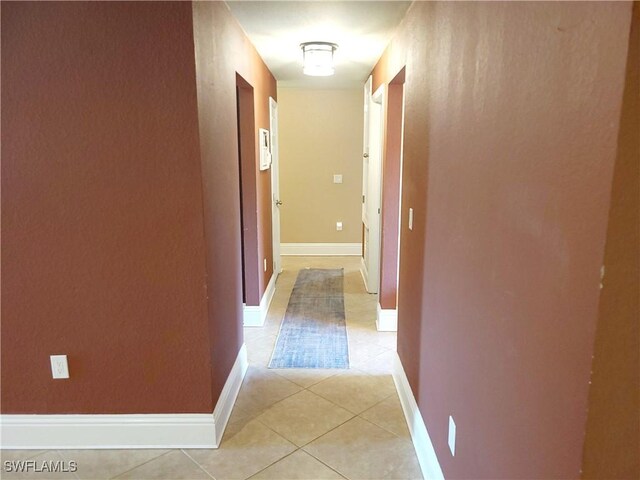 506 Desoto Ave, Lehigh Acres, FL 33972 - hallway featuring light tile patterned flooring and baseboards