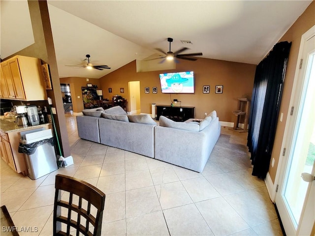 506 Desoto Ave, Lehigh Acres, FL 33972 - living area featuring ceiling fan, vaulted ceiling, light tile patterned floors, and baseboards
