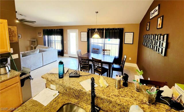 506 Desoto Ave, Lehigh Acres, FL 33972 - dining space with light tile patterned flooring, baseboards, and a ceiling fan