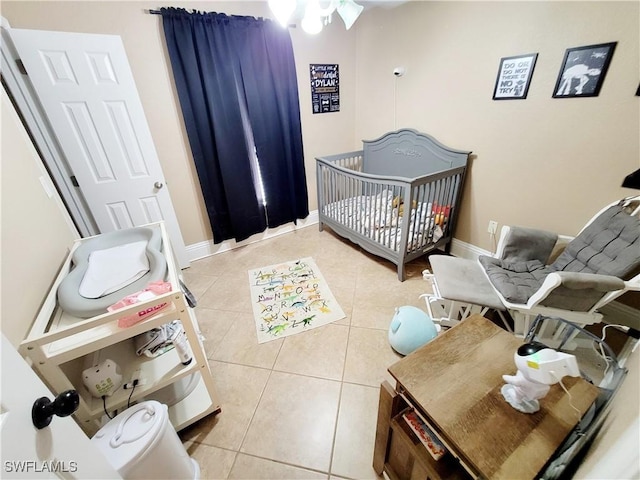 506 Desoto Ave, Lehigh Acres, FL 33972 - tiled bedroom featuring a nursery area and baseboards