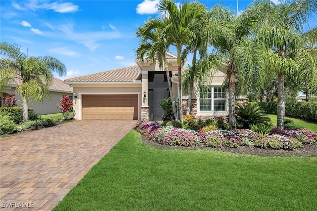 9578 Coquina Cir, Naples, FL 34120 - mediterranean / spanish-style house with a front yard, an attached garage, decorative driveway, and stucco siding