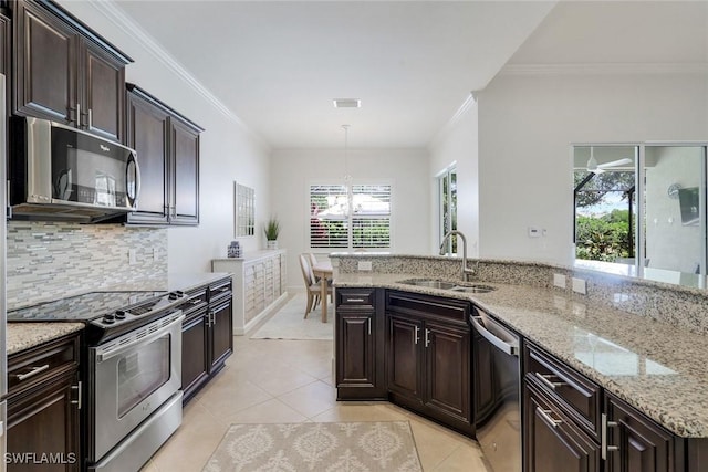 9578 Coquina Cir, Naples, FL 34120 - kitchen with appliances with stainless steel finishes, a sink, crown molding, tasteful backsplash, and light tile patterned floors