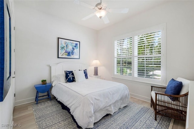 9578 Coquina Cir, Naples, FL 34120 - bedroom with light wood-style flooring, baseboards, and a ceiling fan