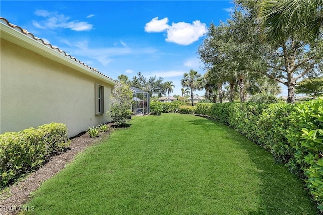 9578 Coquina Cir, Naples, FL 34120 - view of green lawn with a lanai