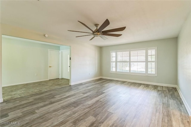 4330 S Canal Cir, North Fort Myers, FL 33903 - spare room with wood finished floors, a ceiling fan, and baseboards