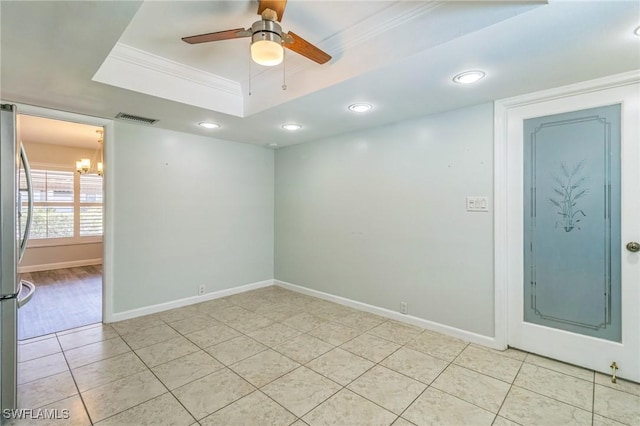 4330 S Canal Cir, North Fort Myers, FL 33903 - empty room featuring a chandelier, light tile patterned floors, a tray ceiling, crown molding, and ceiling fan
