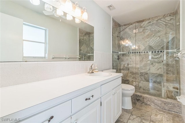 4330 S Canal Cir, North Fort Myers, FL 33903 - bathroom featuring tile walls, toilet, vanity, and a stall shower