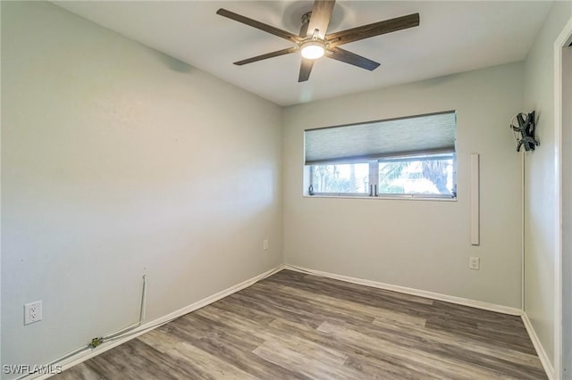 4330 S Canal Cir, North Fort Myers, FL 33903 - empty room featuring wood finished floors, a ceiling fan, and baseboards
